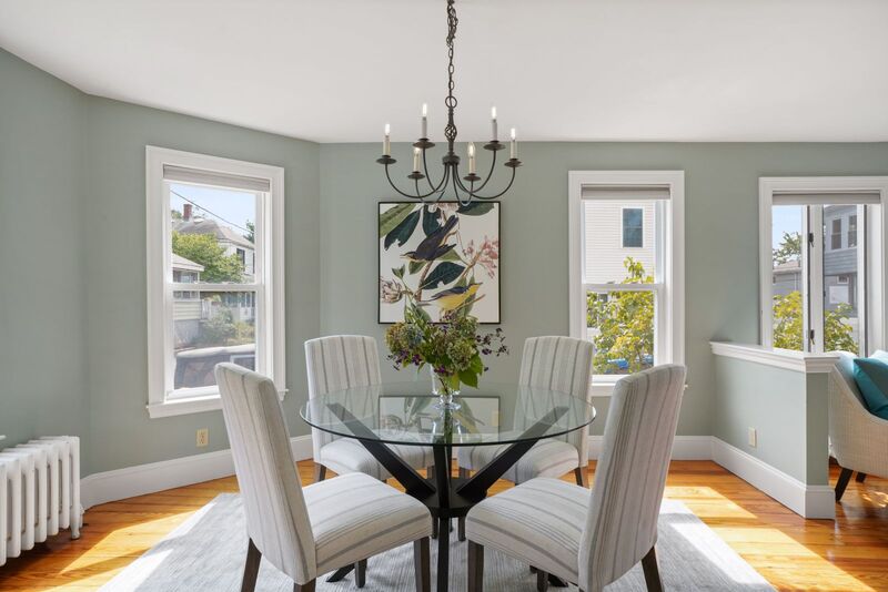 Dining room with chandelier and view of the living room to the right.