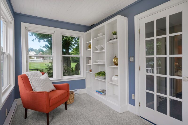 Sun room with sitting area and book shelf