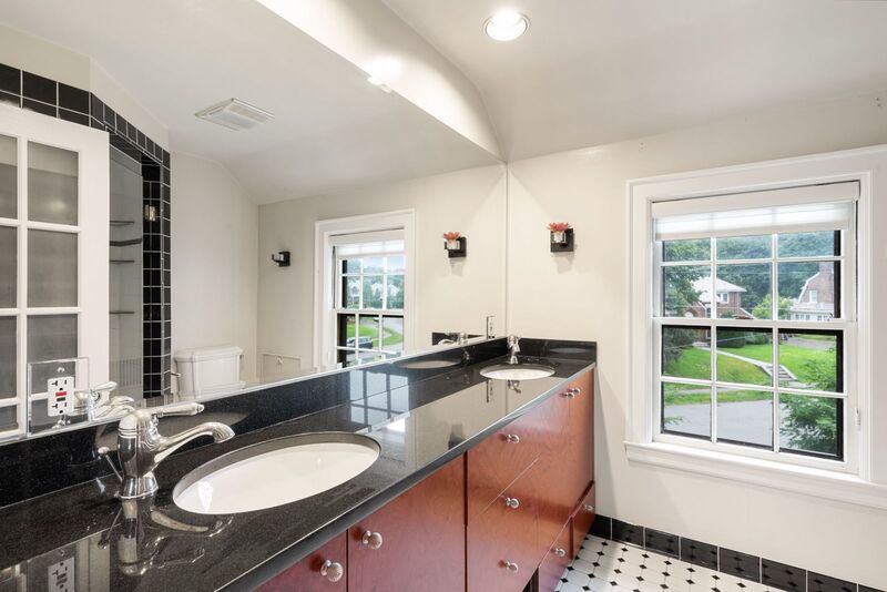 Primary bathroom with double sinks and full wall mirror